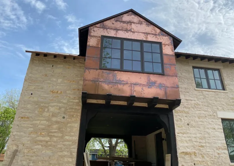 Copper metal panel facade on a stone building for Skylight Installation in Ahuimanu